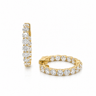 A pair of gold hoop earrings with a row of round-cut clear gemstones, shown on a clean white background. One earring is displayed vertically to show the side profile, and the other is shown horizontally to display the front and clasp.