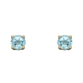 Pair of gold earrings with round light blue gemstones on a white background