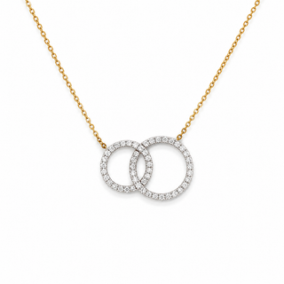 A delicate gold chain necklace featuring two interlocking circular pendant rings paved with small clear stones, set against a plain white background.