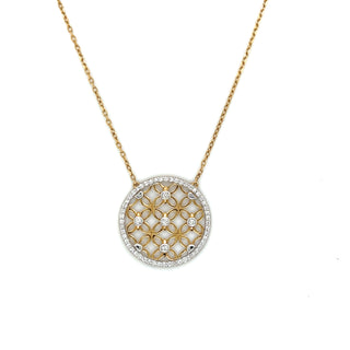 Gold necklace with a round pendant on a white background