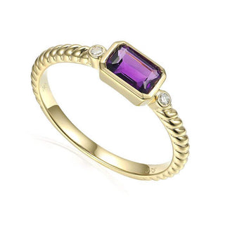 A 9ct yellow gold twist ring with a central amethyst stone and two side diamond accents.