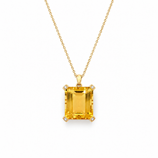 Gold necklace with a round pendant and green beads on a white background