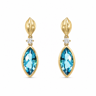 A pair of gold drop earrings featuring marquise-cut light blue topaz stones and a small round clear gemstone accent above, set against a plain white background.