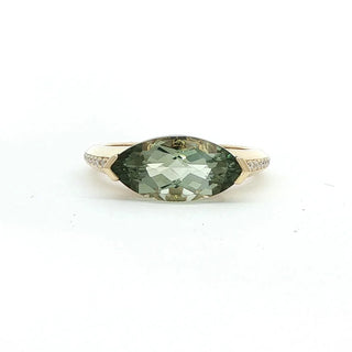 A yellow gold ring featuring a marquise-cut green gemstone, set against a plain white background.