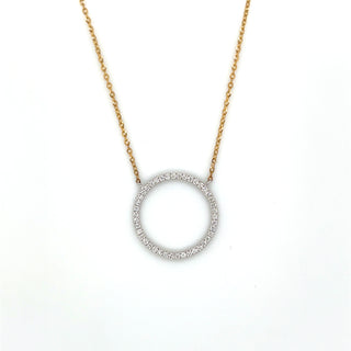 Gold necklace with a circular pendant on a white background