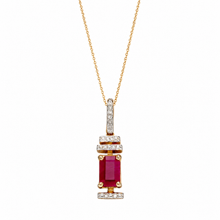 Gold necklace with a red gemstone pendant on a white background