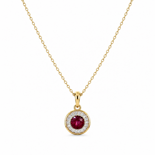 A gold chain necklace with a round pendant featuring a central deep red ruby gemstone surrounded by a halo of small clear stones, shown on a plain white background.