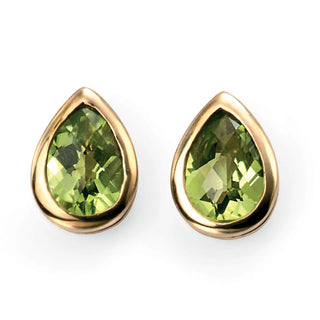 Gold earrings with green gemstones on a white background