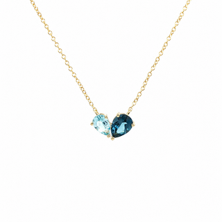 Necklace with a blue pear toi et moi pendant on a white background