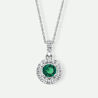 Silver necklace with a green gemstone pendant on a white background