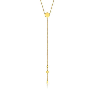 Gold necklace with small round pendants on a white background