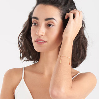 Woman with a gold bracelet on a white background