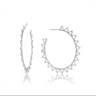 A pair of silver hoop earrings with small triangular shapes around the hoop, displayed against a white background.