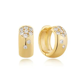 A pair of rhodium-plated sterling silver huggie hoop earrings with a cluster of sparkling cubic zirconia at the front.