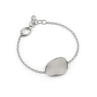white gold bracelet with a unique shaped silver charm on a white background