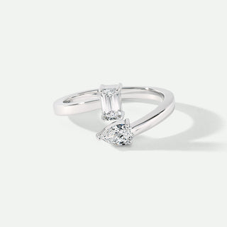Diamond ring with two gemstones on a white background