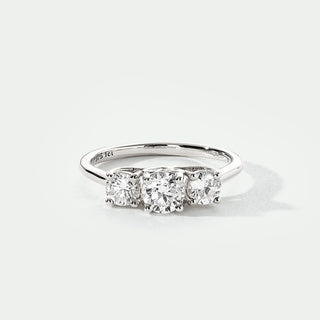 Diamond ring with three stones on a white background