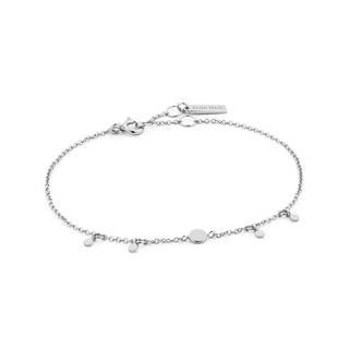 Silver bracelet with small charms on a white background