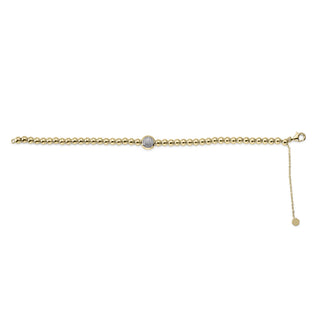 Gold bracelet with a small round charm on a white background