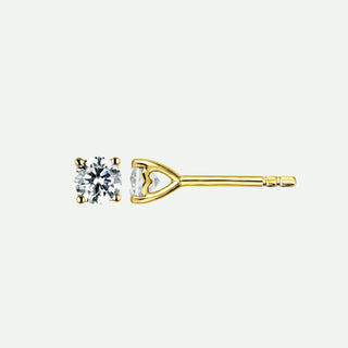 Gold earring with a clear gemstone on a white background