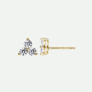 Gold earrings with clear gemstones on a white background