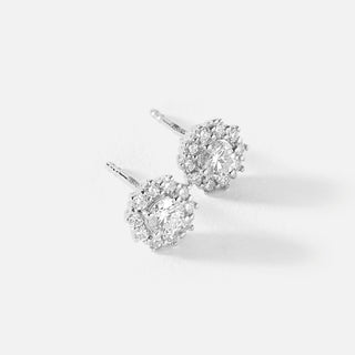 Pair of diamond earrings on a light gray background