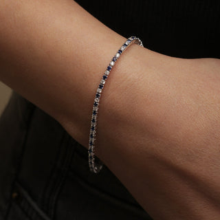 Close-up of a bracelet on a wrist with a dark background