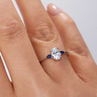 Diamond ring on a finger with a plain background