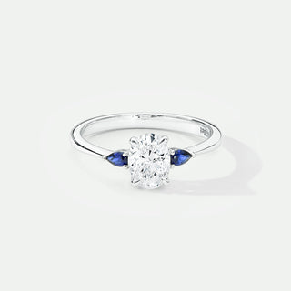 Diamond ring with sapphire side stones on a white background