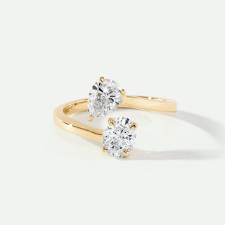 Gold ring with two diamond stones on a white background