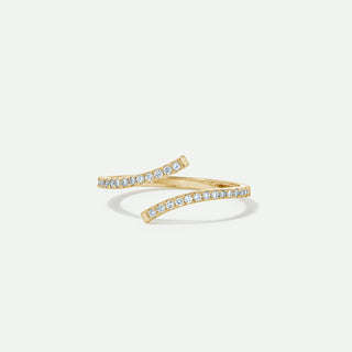 Gold ring with diamond accents on a light gray background
