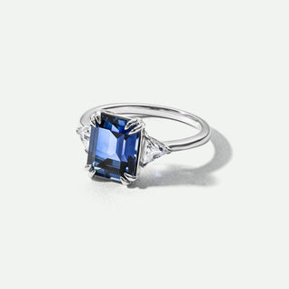 Silver ring with a blue gemstone on a white background