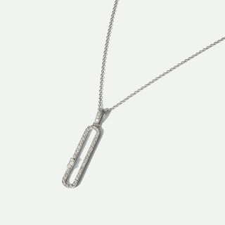 Silver necklace with a unique pendant on a light gray background