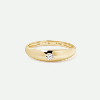 Gold ring with a diamond on a light gray background