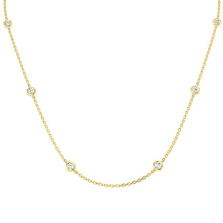 Gold necklace with small diamonds on a white background