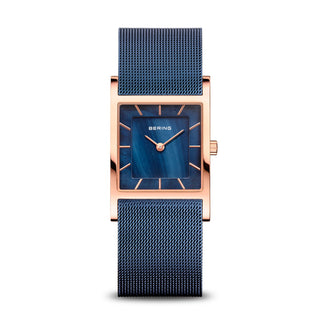 A Bering Classic women's watch with a blue dial, rose gold stainless steel case, and a blue milanese strap.