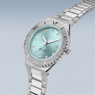 Silver watch with a light blue face on a light gray background