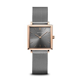 Watch with rose gold case and silver mesh strap on a white background