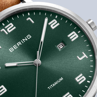 Green watch face with silver accents and 'BERING' branding on a light gray background