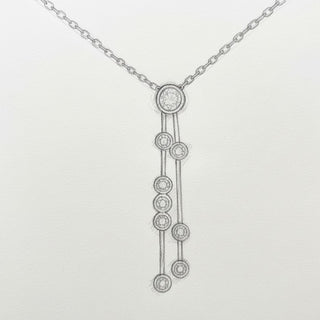 Silver necklace with a unique pendant on a light gray background
