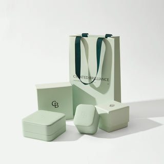 Green jewelry packaging set with 'Created Brilliance' branding on a white background