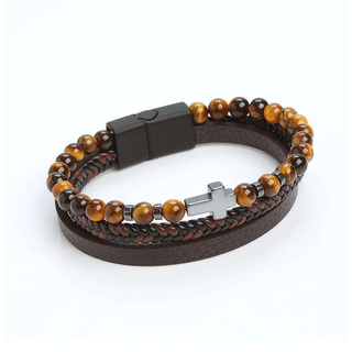 Bracelet with brown leather strap and beaded design on a white background