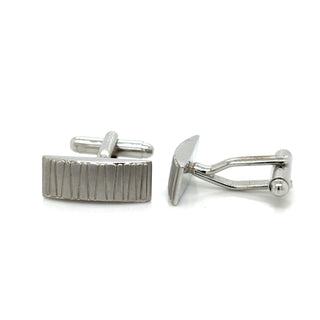Pair of silver cufflinks on a white background
