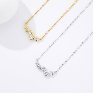 Two necklaces, one gold and one silver, on a white background
