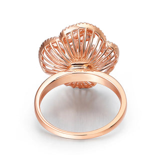 Rose gold shell-shaped ring on a white background