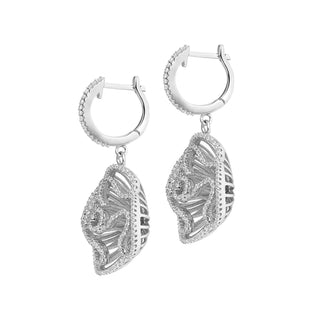 Silver hoop earrings with leaf-like designs on a white background