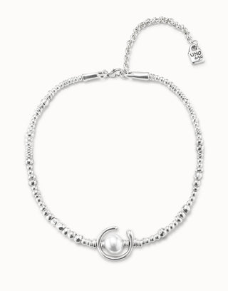 Silver necklace with a pearl charm on a white background