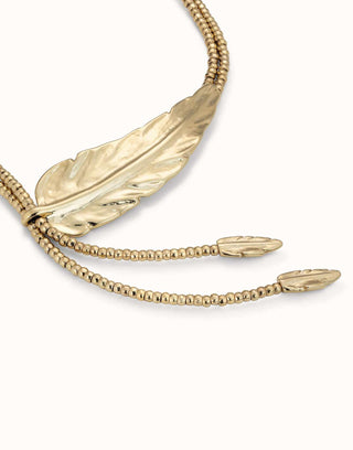 Close-up of the Uno de 50 Golden Feather necklace charm, showing the two small feathers and larger offset feather shape