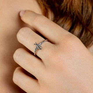 women wearing a silver and ct rose gold ring with a bee design 