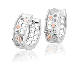 Silver hoop earrings with rose gold accents on a white background